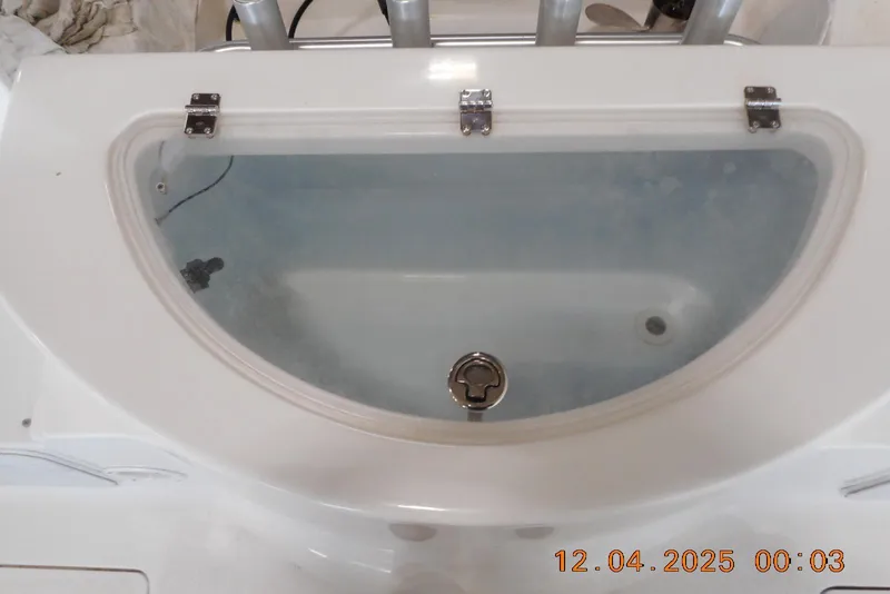 Slide: The Image of Livewell on a 2014 Sea Fox 256 Commander boat, featuring a clear lid and latch. - 17