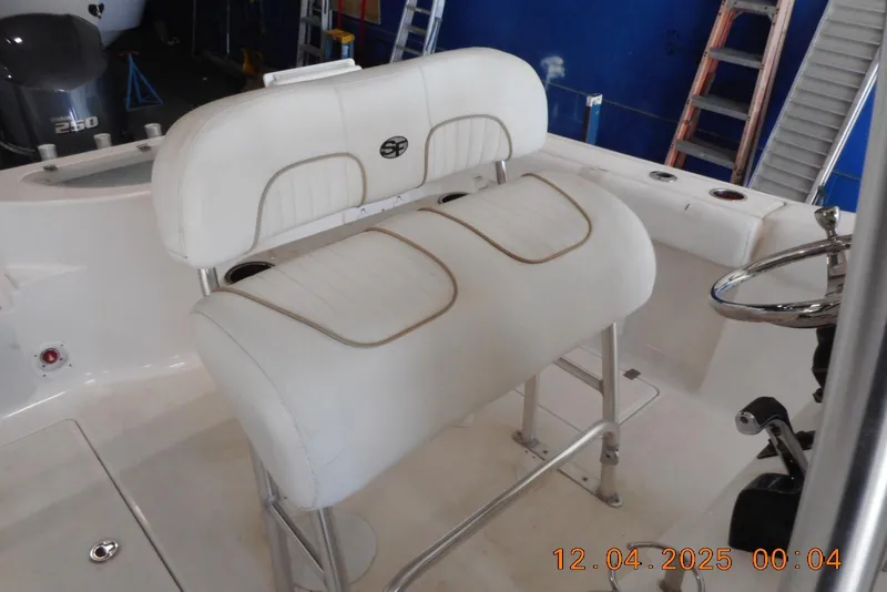 Slide: The Image of 2014 Sea Fox 256 Commander boat interior with white seating and steering wheel. - 21