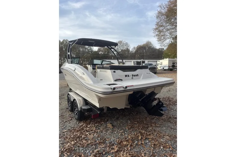 Slide: The Image of 2023 Sea Ray SPX 210 boat with canopy against a dramatic sky backdrop. - 13