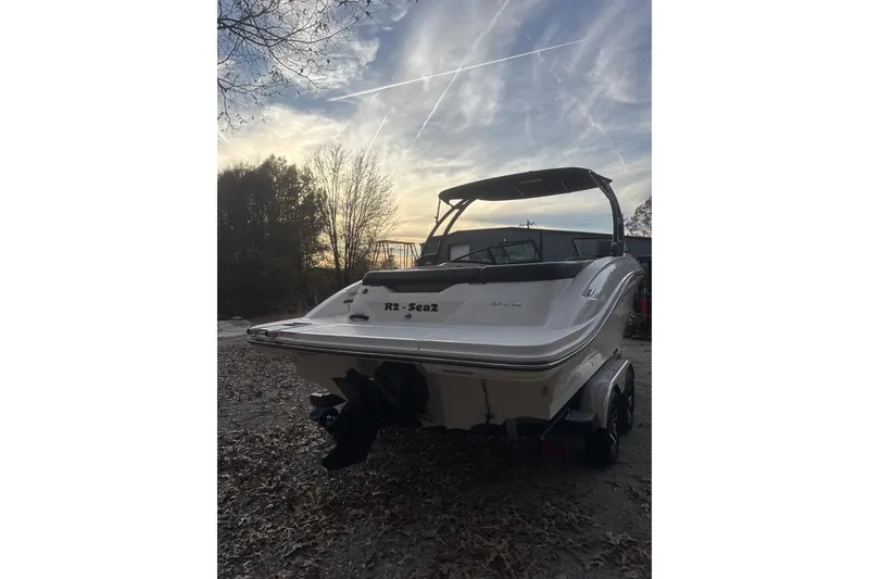 Slide: The Image of 2023 Sea Ray SPX 210 boat on trailer, surrounded by autumn trees. - 15