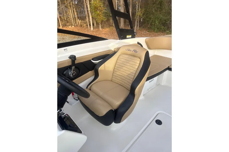 Slide: The Image of 2023 Sea Ray SPX 210 boat dashboard with steering wheel and digital display. - 21
