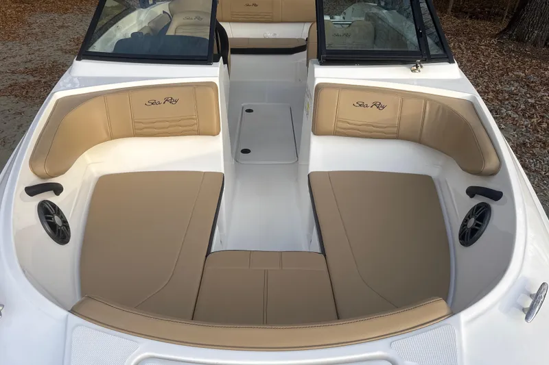 Slide: The Image of 2023 Sea Ray SPX 210 boat interior with tan and black seating. - 22
