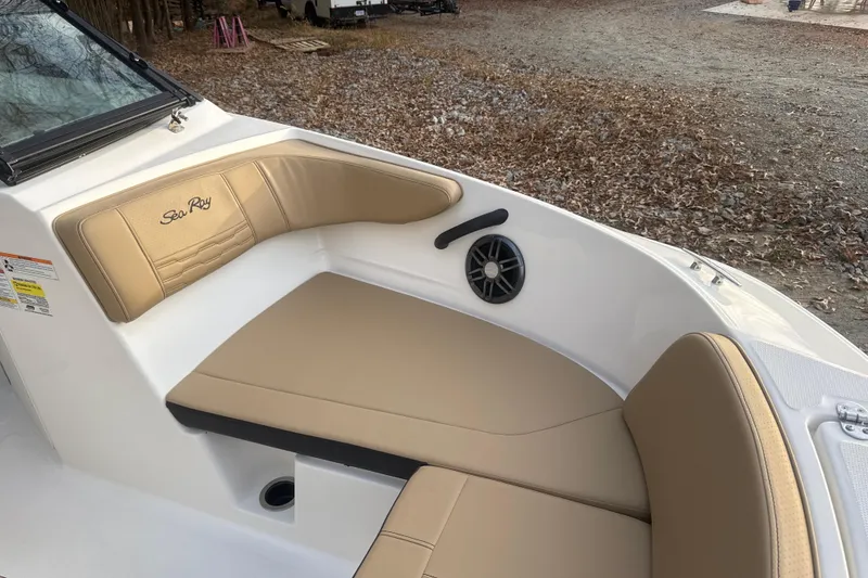Slide: The Image of 2023 Sea Ray SPX 210 boat interior with tan seating and speaker detail. - 24