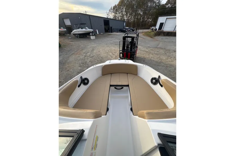 Slide: The Image of 2023 Sea Ray SPX 210 boat interior with tan seating and speaker detail. - 25