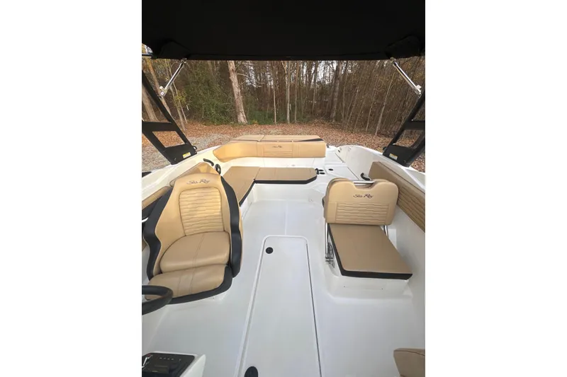 Slide: The Image of 2023 Sea Ray SPX 210 boat interior with tan seating and cup holders. - 28