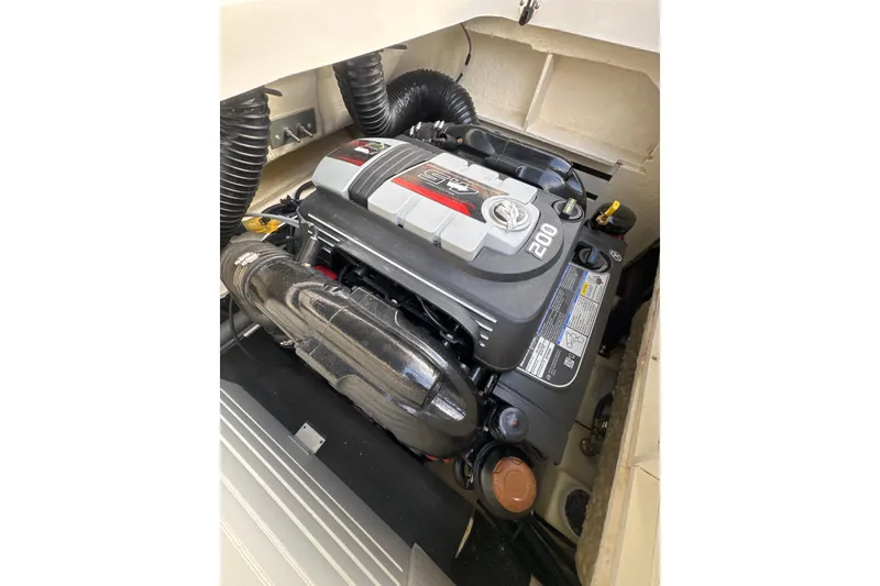 Slide: The Image of 2023 Sea Ray SPX 210 boat with black canopy, surrounded by trees. - 30