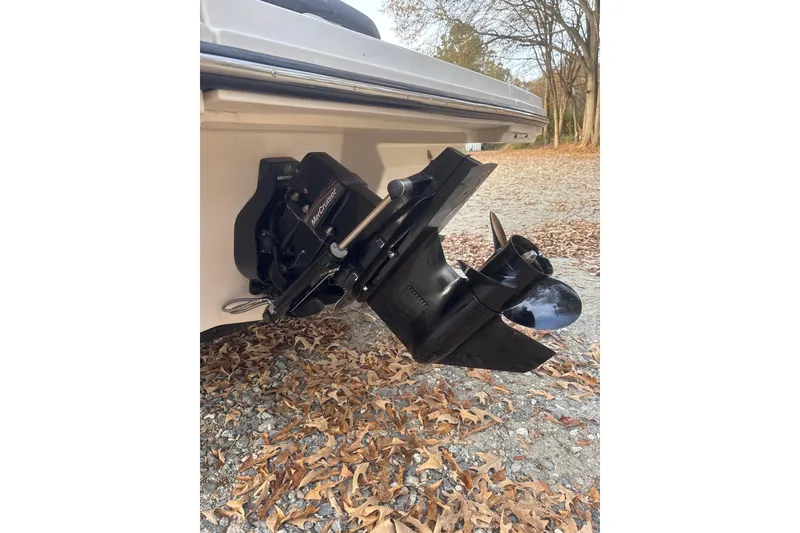 Slide: The Image of 2023 Sea Ray SPX 210 boat stern with propeller, surrounded by dry leaves. - 33