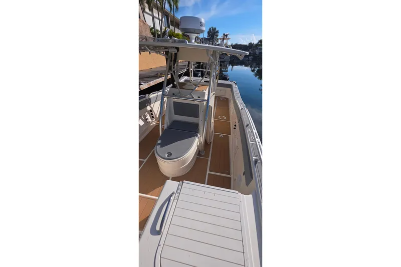 Slide: The Image of 2004 World Cat 330 TE boat interior with canopy, docked by waterfront homes. - 15