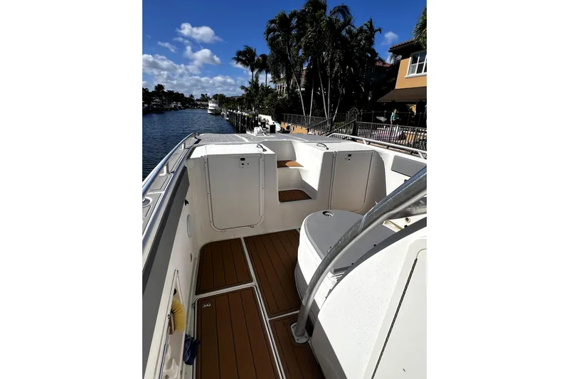 Slide: The Image of 2004 World Cat 330 TE boat docked in a sunny canal setting. - 5