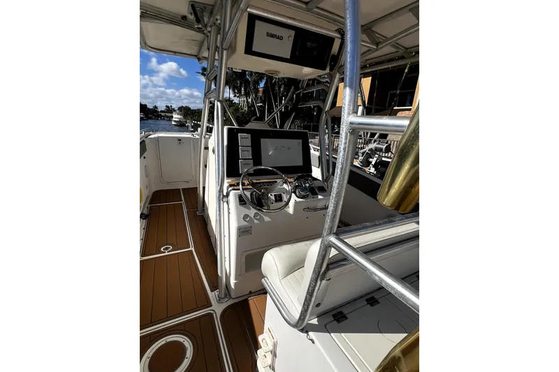 Slide: The Image of 2004 World Cat 330 TE boat interior with teak flooring and fishing rod holders. - 8