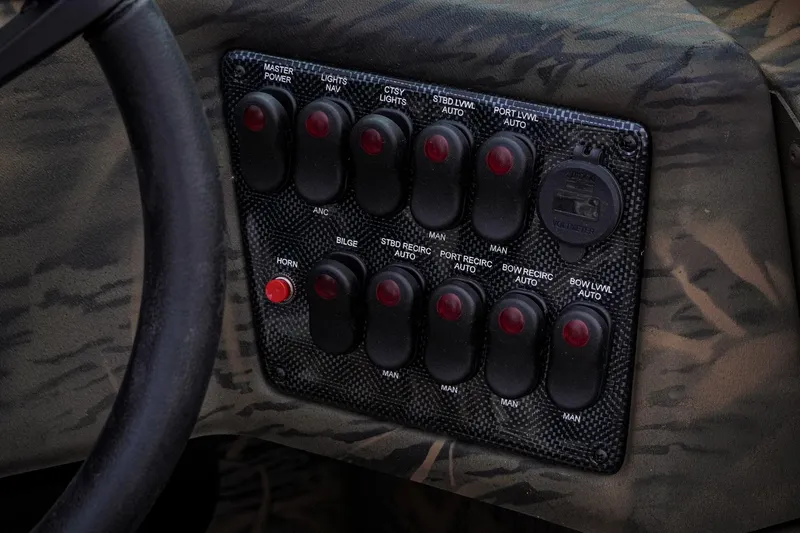 Slide: The Image of Control panel of 2026 G3 Sportsman 2100 boat with various switches and buttons. - 10