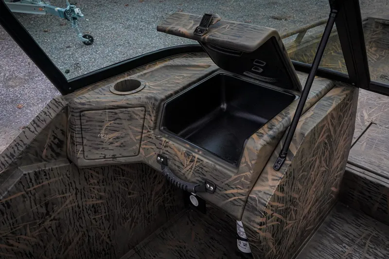 Slide: The Image of 2026 G3 Sportsman 2100 boat interior with camo design and storage compartment. - 12