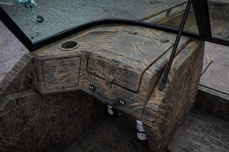 Slide: The Image of 2026 G3 Sportsman 2100 boat interior with camouflage design and storage compartments. - 13
