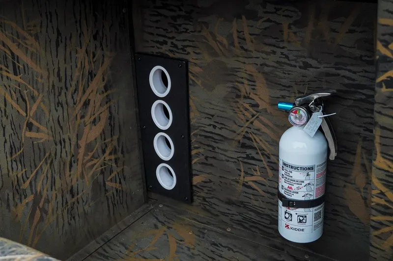 Slide: The Image of Fire extinguisher mounted on G3 Sportsman 2100 boat, 2026 model, with camouflage interior. - 14