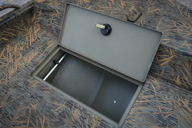 Slide: The Image of Open storage compartment on 2026 G3 Sportsman 2100 boat with camouflage pattern. - 18
