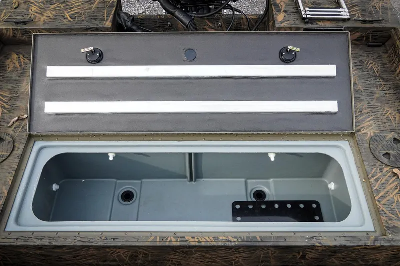 Slide: The Image of 2026 G3 Sportsman 2100 boat livewell with open lid, showcasing interior compartments. - 22