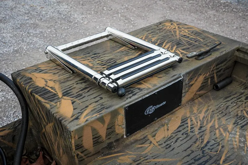 Slide: The Image of 2026 G3 Sportsman 2100 boat with camouflage design and foldable ladder. - 24