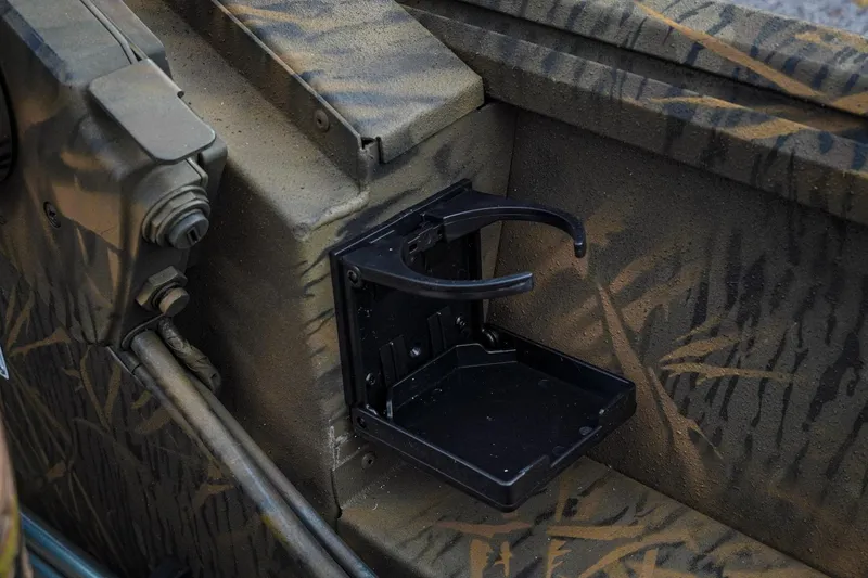 Slide: The Image of 2026 G3 Sportsman 2100 boat with camouflage design and foldable cup holder. - 26