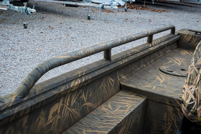 Slide: The Image of 2026 G3 Sportsman 2100 boat with camouflage design, gravel background. - 27