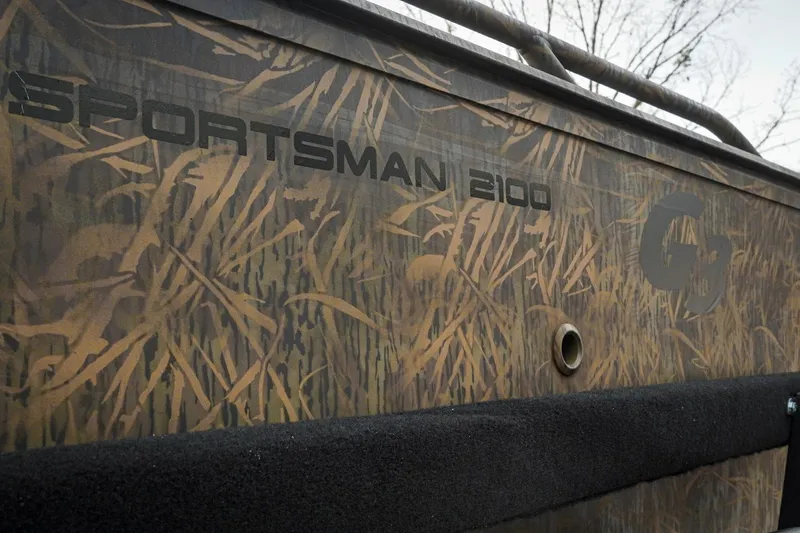 Slide: The Image of 2026 G3 Sportsman 2100 boat with camouflage design and branding. - 31