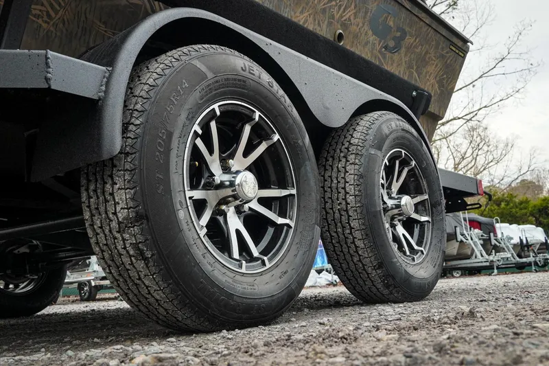 Slide: The Image of 2026 G3 Sportsman 2100 trailer with dual wheels on gravel surface. - 35