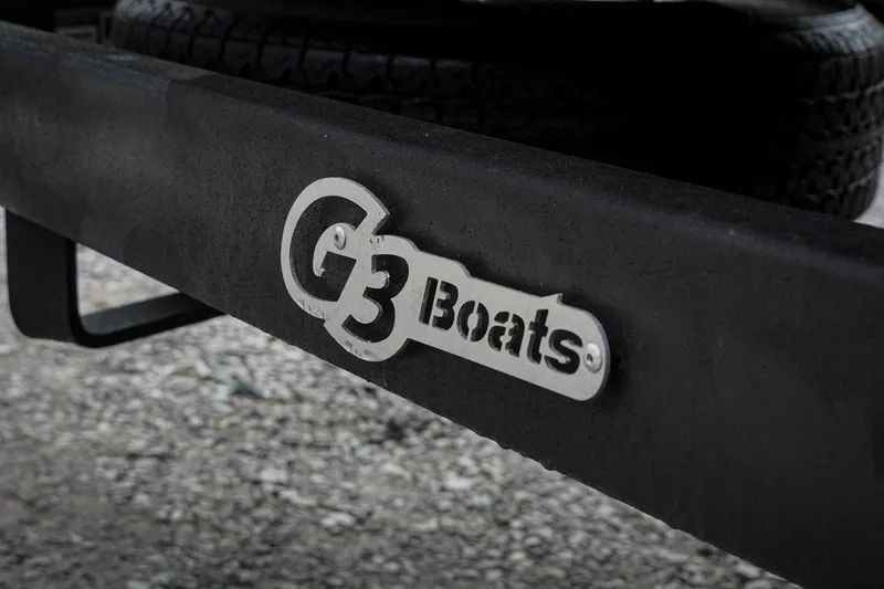 Slide: The Image of G3 Boats logo on a 2026 Sportsman 2100 trailer, with gravel background. - 36