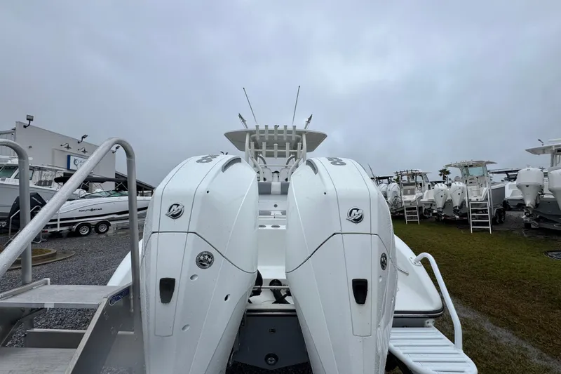 Slide: The Image of 2007 Yellowfin 31 Center Console boat with dual outboard engines, displayed outdoors. - 13
