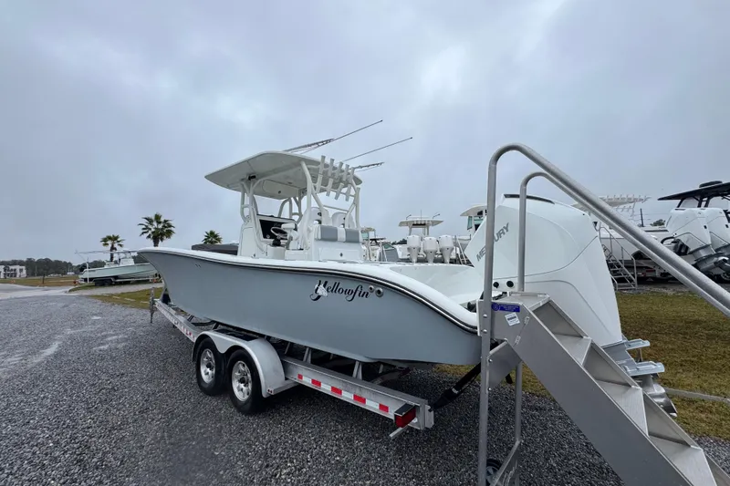 Slide: The Image of 2007 Yellowfin 31 Center Console boat on trailer, overcast day, palm trees in background. - 15