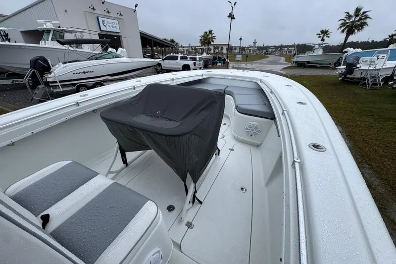 Slide: The Image of 2007 Yellowfin 31 Center Console boat with wet seating, parked near a marina. - 16
