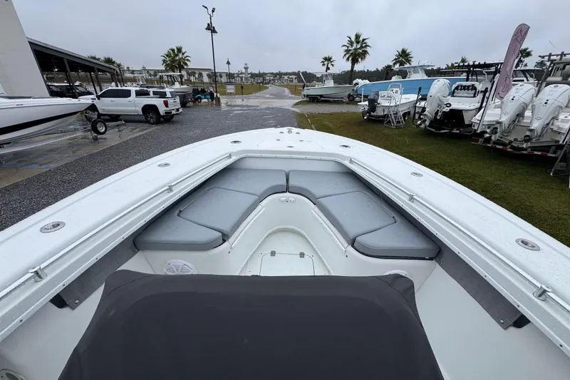 Slide: The Image of 2007 Yellowfin 31 Center Console boat with cushioned seating, parked outdoors on a rainy day. - 17