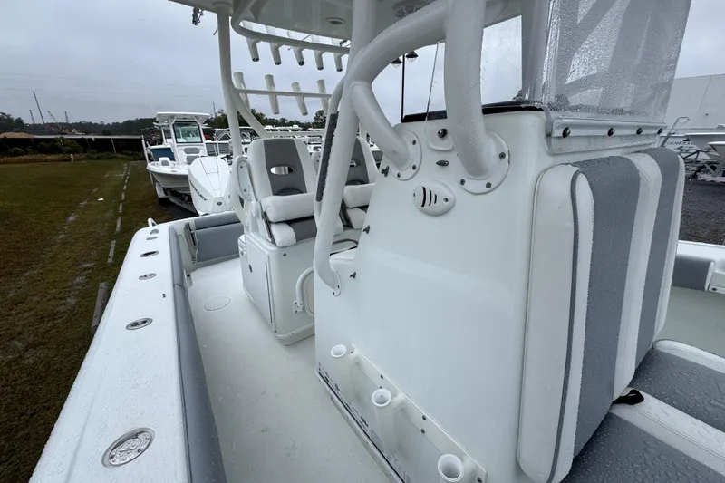 Slide: The Image of 2007 Yellowfin 31 Center Console boat with seating and rod holders on a rainy day. - 20