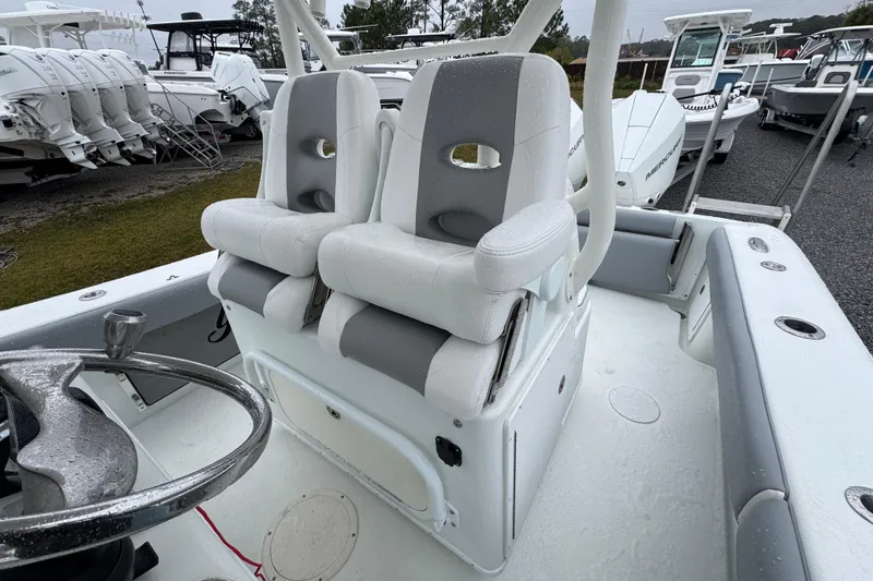 Slide: The Image of 2007 Yellowfin 31 Center Console boat with dual seats and steering wheel, parked outdoors. - 21