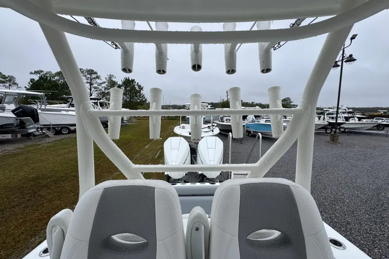 Slide: The Image of 2007 Yellowfin 31 Center Console boat with rod holders, parked in a marina. - 23