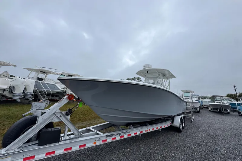Slide: The Image of 2007 Yellowfin 31 Center Console boat on trailer under cloudy sky. - 4