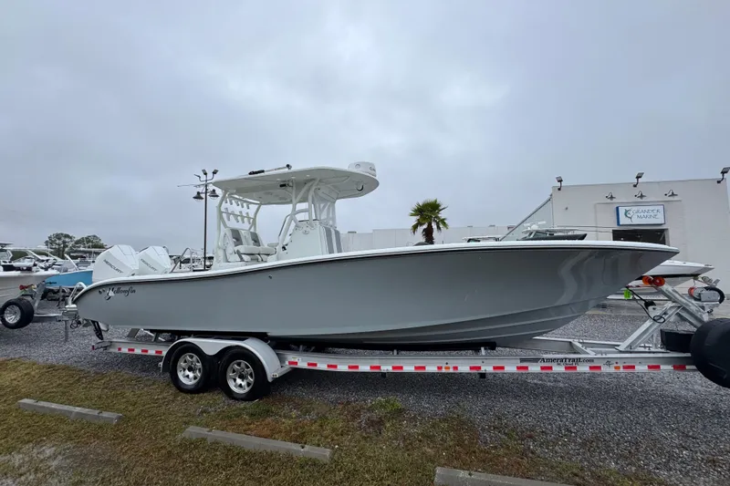 Slide: The Image of 2007 Yellowfin 31 Center Console boat on trailer, parked outdoors on a cloudy day. - 9