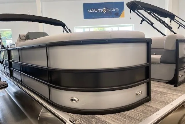 Slide: The Image of 2026 Bentley Pontoons Legacy 243 Navigator in showroom, featuring sleek design and modern seating. - 1