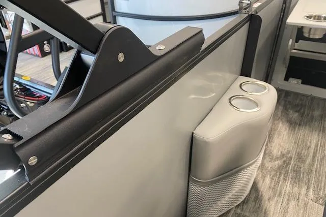 Slide: The Image of 2026 Bentley Pontoons Legacy 243 Navigator interior with cup holders and sleek design. - 12