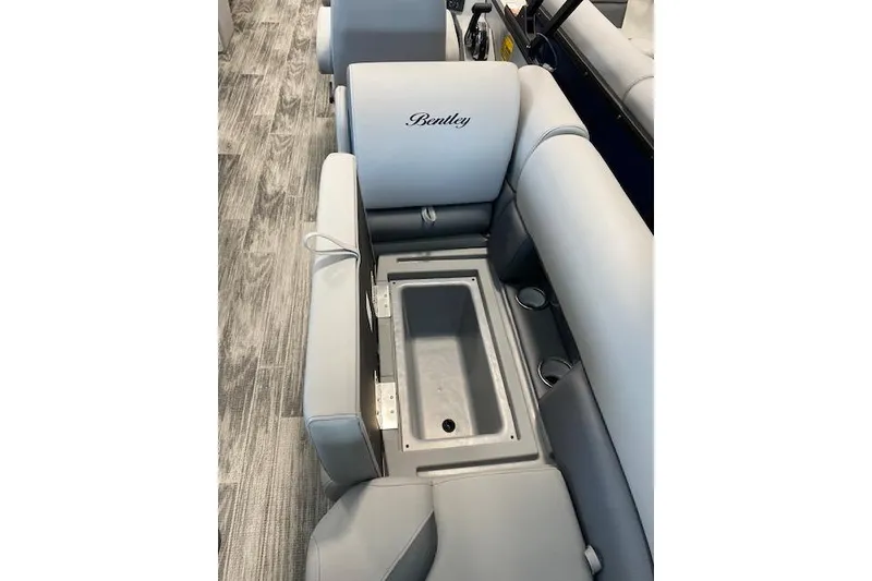 Slide: The Image of 2026 Bentley Pontoons Legacy 243 Navigator interior seating with integrated storage compartment. - 13