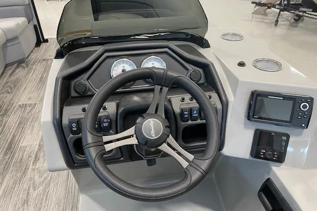 Slide: The Image of Steering console of 2026 Bentley Pontoons Legacy 243 Navigator with modern controls and gauges. - 5