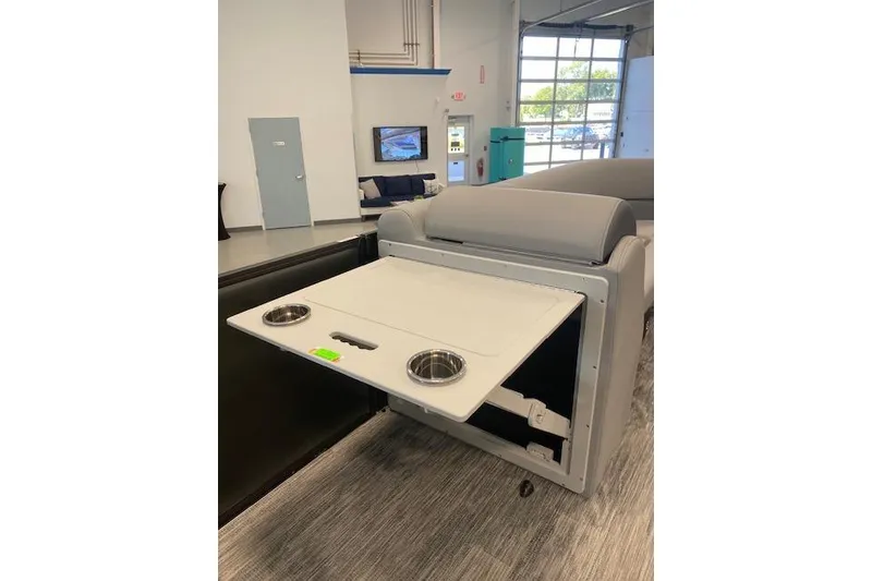 Slide: The Image of 2026 Bentley Pontoons Legacy 243 Navigator interior with fold-out table and cup holders. - 4