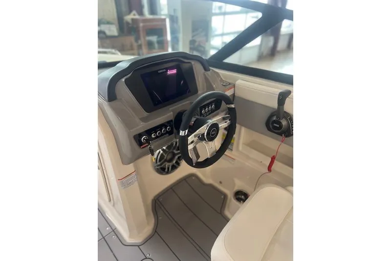 Slide: The Image of 2025 Chaparral 23 Surf boat interior with modern steering and control panel. - 11
