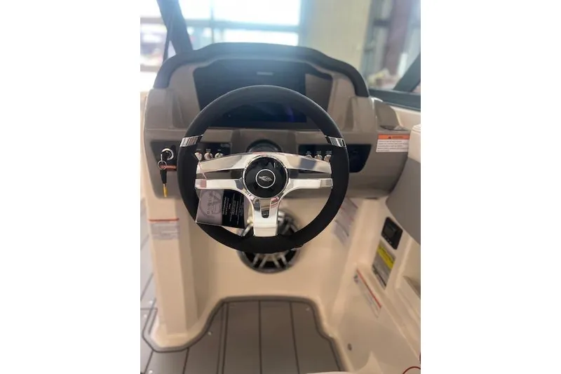 Slide: The Image of Steering wheel of 2025 Chaparral 23 Surf boat, featuring modern dashboard design. - 12