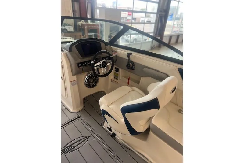 Slide: The Image of Interior of 2025 Chaparral 23 Surf boat with modern steering and seating. - 13