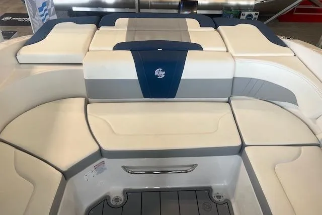 Slide: The Image of 2025 Chaparral 23 Surf boat interior with cushioned seating and sleek design. - 14