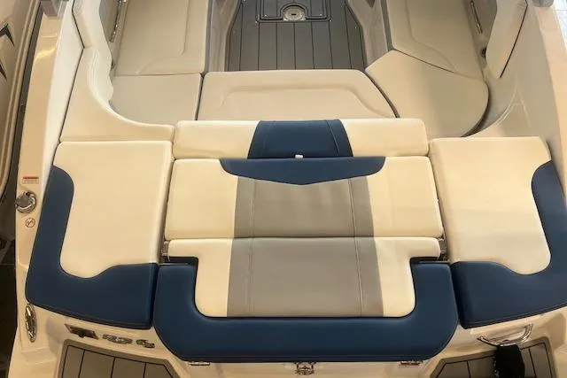 Slide: The Image of 2025 Chaparral 23 Surf boat interior with blue and beige seating. - 21