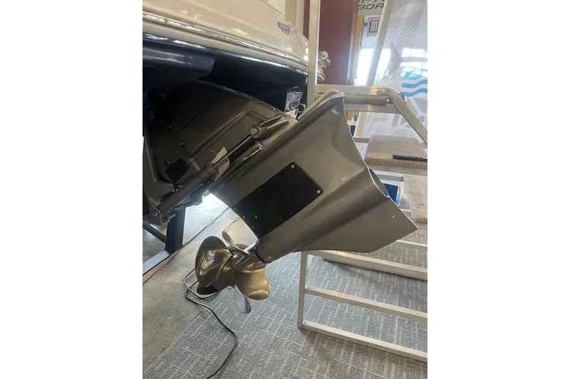 Slide: The Image of 2025 Chaparral 23 Surf boat propeller and outdrive detail in showroom setting. - 25