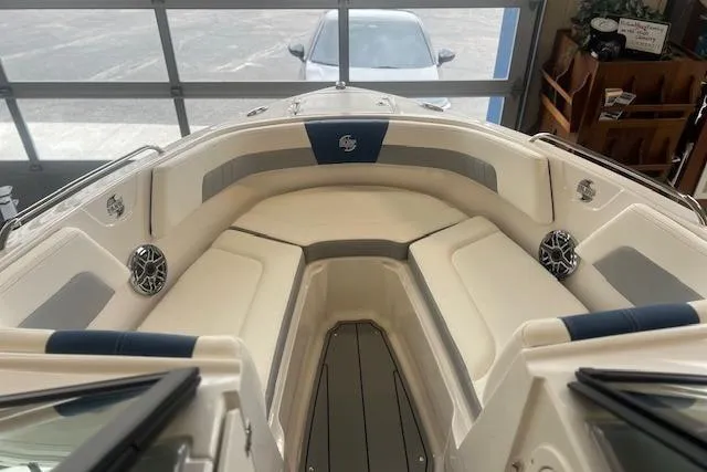 Slide: The Image of 2025 Chaparral 23 Surf boat interior with cushioned seating and speakers. - 3