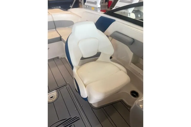 Slide: The Image of 2025 Chaparral 23 Surf boat interior with white and blue seating. - 6