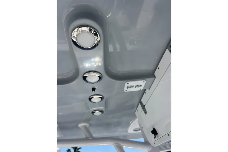 Slide: The Image of Ceiling view of 2004 Sea Hunt Ultra 234 boat with recessed lights and control panel. - 13