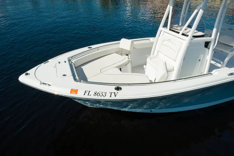 Slide: The Image of 2004 Sea Hunt Ultra 234 boat on calm water, Florida registration visible. - 6
